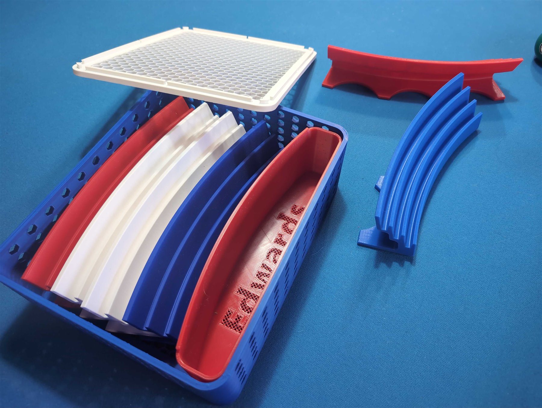 MeldVault 4 open storage box with trays, storage troughs, and lid arranged on a table.