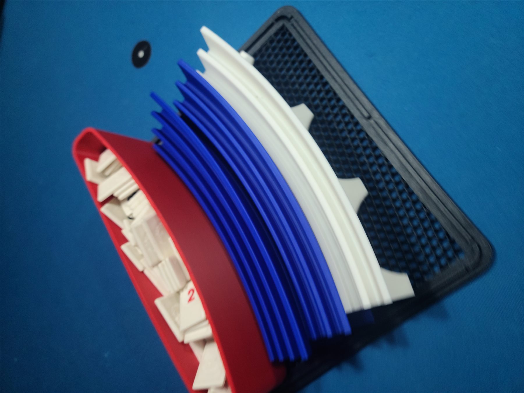 Close-up of stacked tray components in the storage box.